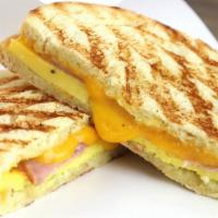 Breakfast Sandwich  · Scrambled egg, garlic herb spread, ham or bacon and your choice of cheese.