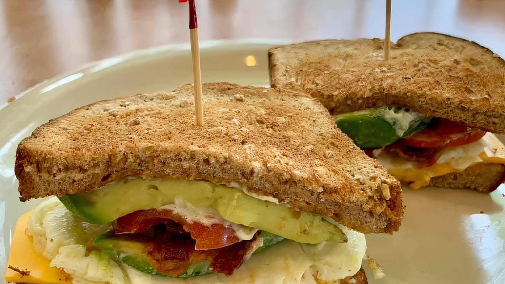 The Trainer · Egg white sandwich on wheat bread with bacon, cheddar, tomato, and avocado.