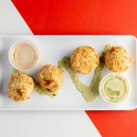 Boudin Balls · A classic Cajun staple. Four pieces breaded, fried , and served with multiple side sauces. T...