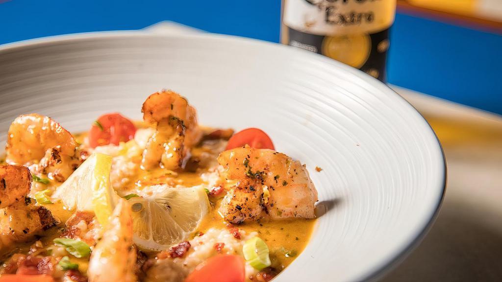 Shrimp And Grits  · Savory Grilled Shrimp resting in creamy grits topped with a smoked cream, chipotle, bacon, tomatoes, and green onions