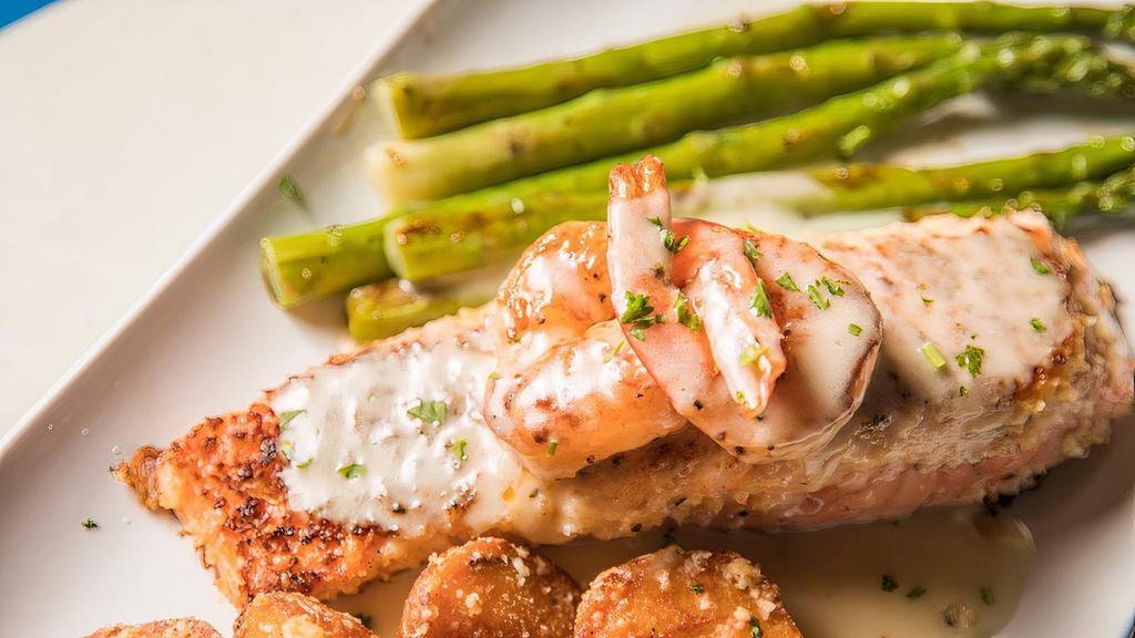 Bourree Blanc · Seared crusted Salmon and grilled Shrimp topped with a classic Bourree Sauce served with roasted garlic red potatoes and grilled asparagus.