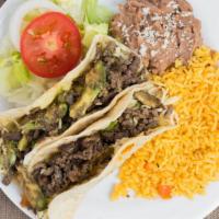 Pirata Plate · Two flour tortillas white melted cheese beef steak avocado grilled onions rice refried beans.