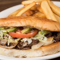 Torta De Bistec · Beef steak grilled onions avocado white melted cheese mayonnaise lettuce tomatoes fries.