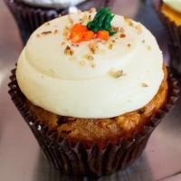 Carrot Cake · Carrot cake baked with pecans and coconut flakes, and garnished with cream cheese