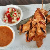 Chicken Satay (Satay Gai) · with Massaman peanut dipping sauce.