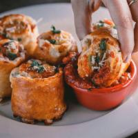 Sicilian Pepperoni Rolls™ · Signature dough with pepperoni, green onions and cheese. Baked and served with pizza sauce.