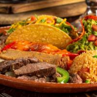 Deluxe Mexican Dinner · famous beef fajitas, cheese enchilada, tamal & a crispy taco, served with guacamole, frijole...