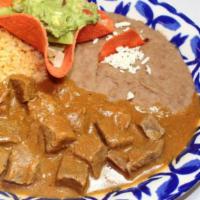 El Vaquero · your choice of carne guisada or puerco en chile cascabel, served with guacamole, frijoles re...