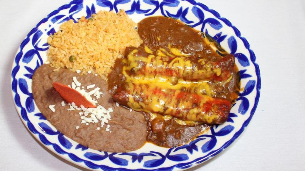 Enchiladas San Antonio · two cheese enchiladas topped with our chili meat gravy & aged cheddar cheese, served with frijoles refritos & Spanish rice.