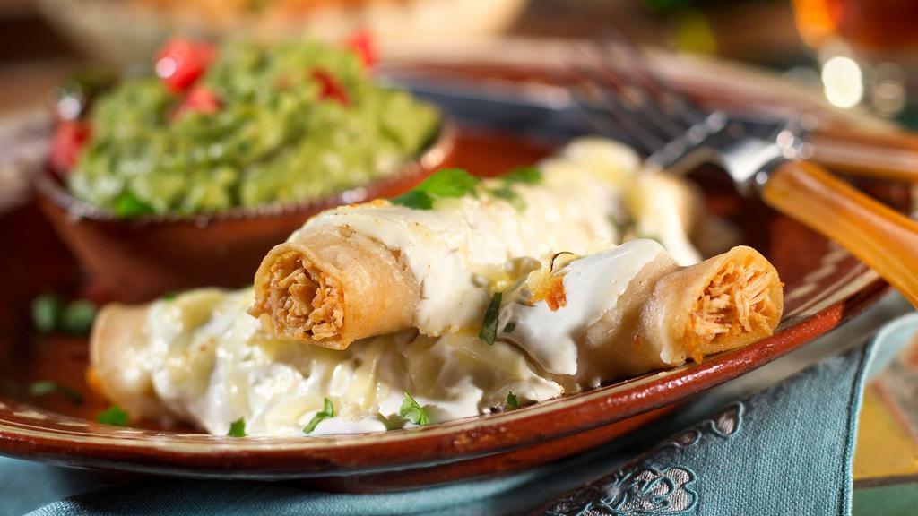 Enchiladas Sour Cream · two chicken enchiladas smothered in sour cream sauce & Monterey jack cheese, served with frijoles refritos & Spanish rice.