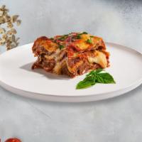 Lasagna · Layers of pasta, ricotta, mozzarella, ground beef, and tomato sauce baked in an oven and top...