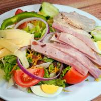 Chef'S Salad · A bed of crisp lettuce with roasted turkey, ham, bacon, American and Swiss cheese, quartered...