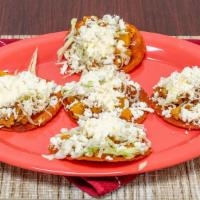 Tacos Estillo San Luis · 5 mini tacos of Papa Y Chorizo. topped with cabbage, cheese, and sour cream.