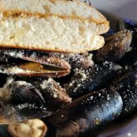 Mussels · One lb. Of mussels steamed in garlic butter-lemon broth & served with two pieces of garlic b...
