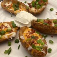 Potato Skins · Chunky, skin-on fries topped with cheese, bacon & onions.