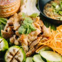 G12-Moo Plara · Grilled pork shoulder marinated in fermented fish sauce. Served with sticky rice, fresh vege...
