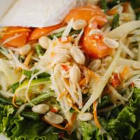 L1-Tum Thai · Original Thai styled spicy papaya salad with tomatoes, green beans, carrot, and peanut.