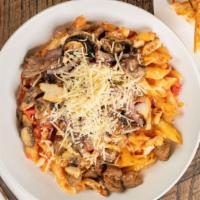 Baked Pasta Arrabbiata · Penne with spicy pink sauce, Italian sausage, chicken, mushrooms, onions and sun-dried tomat...