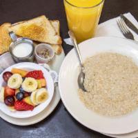 Oatmeal Breakfast · Bowl of oatmeal topped with raisins & pecan, served with fresh fruit and whole wheat toast.