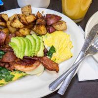 Blt Omelette · Three eggs omelette style with spinach and swiss cheese; topped with two sliced tomatoes, tw...