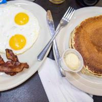 Pancake Combo · With two pancakes, two eggs, and choice of bacon or sausage.