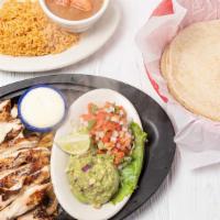 Chicken Fajitas · Chicken with the perfect touch of seasoning. Served with guacamole, pico de gallo, rice, bea...