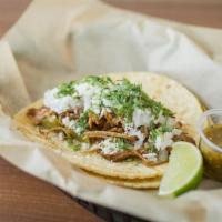 Green Chile Pork · Slow-roasted pork carnitas simmered with green chiles and topped with cotija cheese, cilantr...