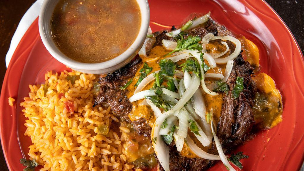 Asada & Enchiladas · Grilled asada steak with marinated onions, cilantro and chimichurri sauce. On top of two cheese enchiladas with Verde sauce. With refried beans and rice.