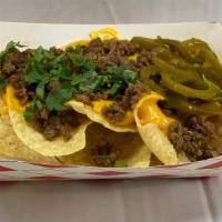 Nachos W Fajita · Mexican torilla chips covered in cheeddar cheese toppeed with beef fajita, a drizzle of sour...