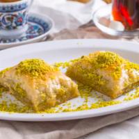 Pistachio Baklava (2 Pc) · Layers of phyllo filled with chopped pistachios and butter, held together with sugar syrup.