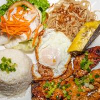 Hung Cuong'S Special Rice Plate · Grilled pork chop, shredded pork skin, quiche and a sunny side up egg.