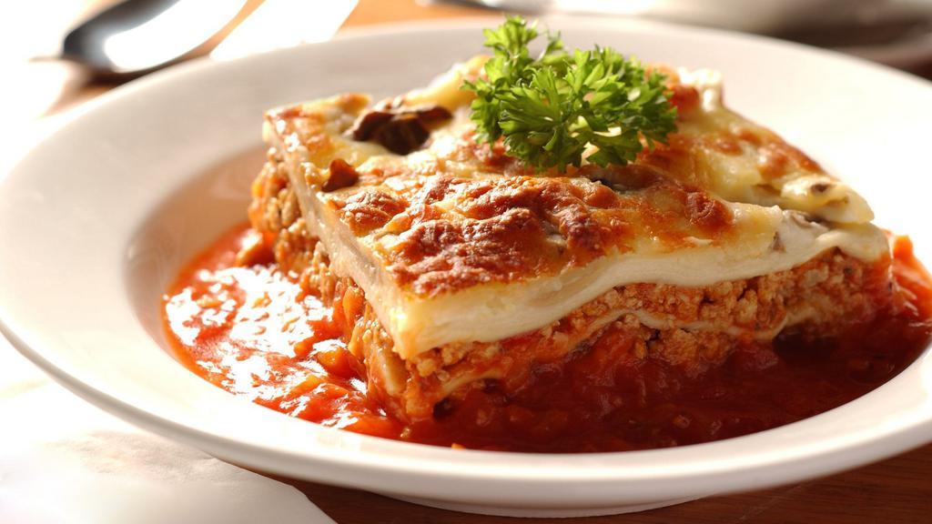 Homemade Lasagna · (5) High layers of Ground Beef, Ricotta, Mozzarella, and Tomato Sauce.
