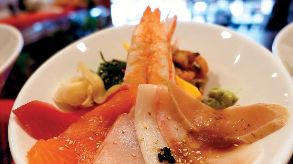 Chirashi Don · Rice bowl with ahi tuna, smoked salmon, yellowtail, red snapper, albacore, shrimp, Japanese sweet egg, crab stick, seaweed & squid salad, served with Japanese mustard and yuzu sauce.