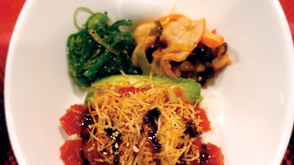 Tekka Don · Rice bowl with sushi-grade raw ahi tuna marinated with spicy sauce, served with squid salad, crispy onion, and sweet eel sauce on top.
