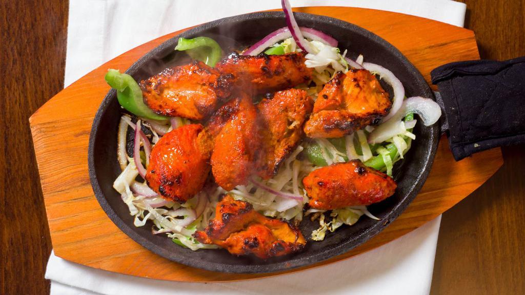Chicken Tikka Masala · Boneless chicken white meat marinated in yogurt, skewed and cooked in special herbs and spices.
