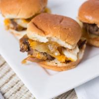 Old School Sliders · 3 mini burgers with grilled onions, cheddar cheese, mustard and mayo on a sweet grill.