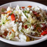 Chopped Wedge · Iceberg, bacon, tomatoes, red onion, roasted peppers, and gorgonzola dressing.