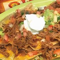 Brisket Nachos · Served with beans and cheese, pico, frijoles charros, guacamole, and sour cream on the side.