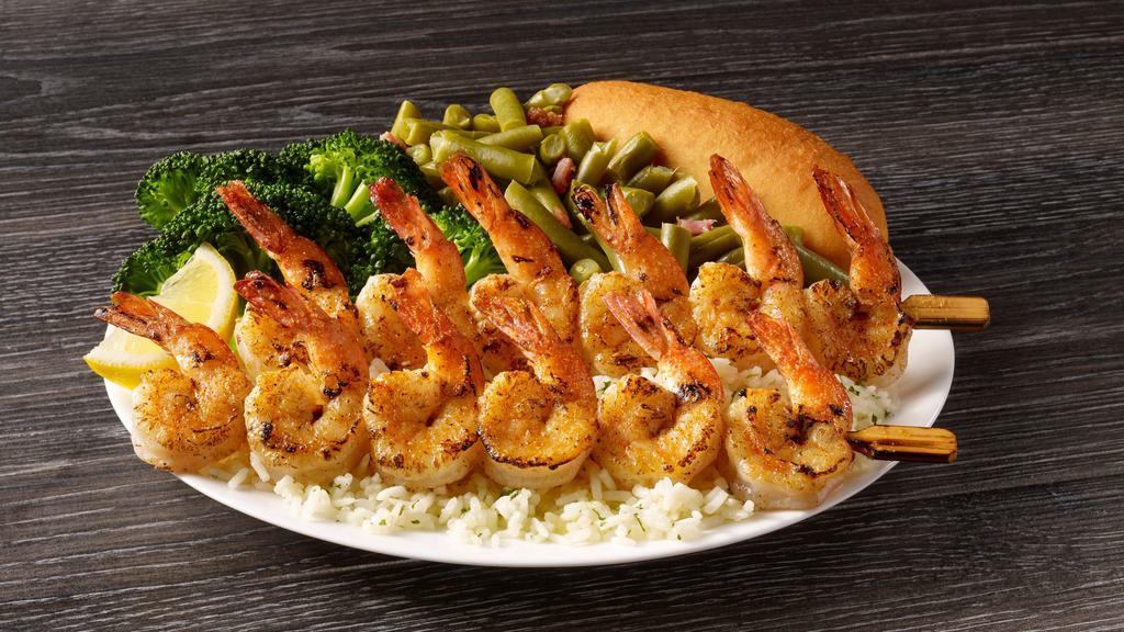 Shrimp Skewers Meal · Plump seasoned shrimp that are seared to perfection and served on a bed of rice with your choice of two sides and a breadstick.
