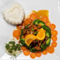 Orange Chicken · Pieces of fried chicken breast in a caramelized orange sauce with broccoli, peas & carrot.