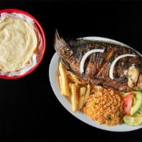 Mojarra Frita · Whole fried tilapia rice, salad and tortillas on the side.