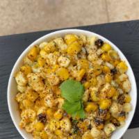 Coconut Creamed Corn (Bowl) · Coconut creamed corn topped with lemon pepper seasoning cilantro and fried onions.
