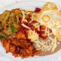 Huevos Con Chilaquiles Y Chicharron Plate · 2 eggs with chopped enchiladas with cheese and pork rinds in green sauce.