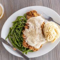Chicken Fried Steak · Tender hand cut steak breaded in house, creamy mashed potatoes, green beans, and Southern wh...