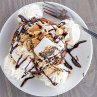 Smores Cake · Crumbly graham cake with a chocolate lava center topped with marshmallow, graham cracker cru...