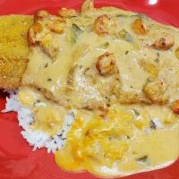 Catfish Acadian · Grilled or fried catfish over white rice, covered in crawfish etouffee.