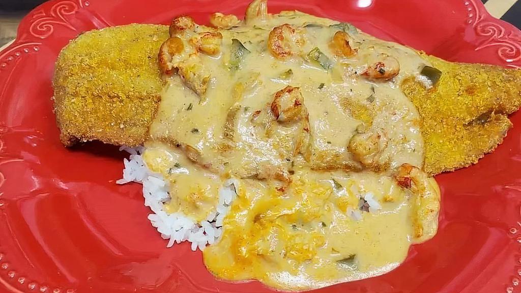 Catfish Acadian · Grilled or fried catfish over white rice, covered in crawfish etouffee.