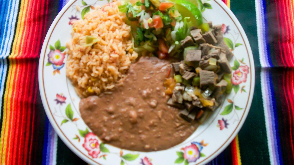 Lengua Plate (Beef Tongue) · Lengua (Beef Tongue) served with Mexican Rice, Refried Beans, Salsa, Lettuce, Tomato, Lime, and Two Handmade Flour Tortillas. Corn tortilla substitution allowed.