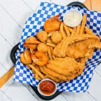 Shrimp And Catfish Basket · 4 shrimp and 2 catfish fillets with French fries and hush puppies.