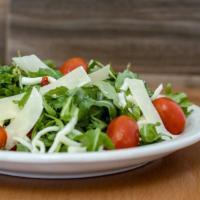 Italian-Style Treciolina Salad · Organic baby arugula, spinach, shaved parmesan, cherry tomato, and mozzarella cheese in a ba...